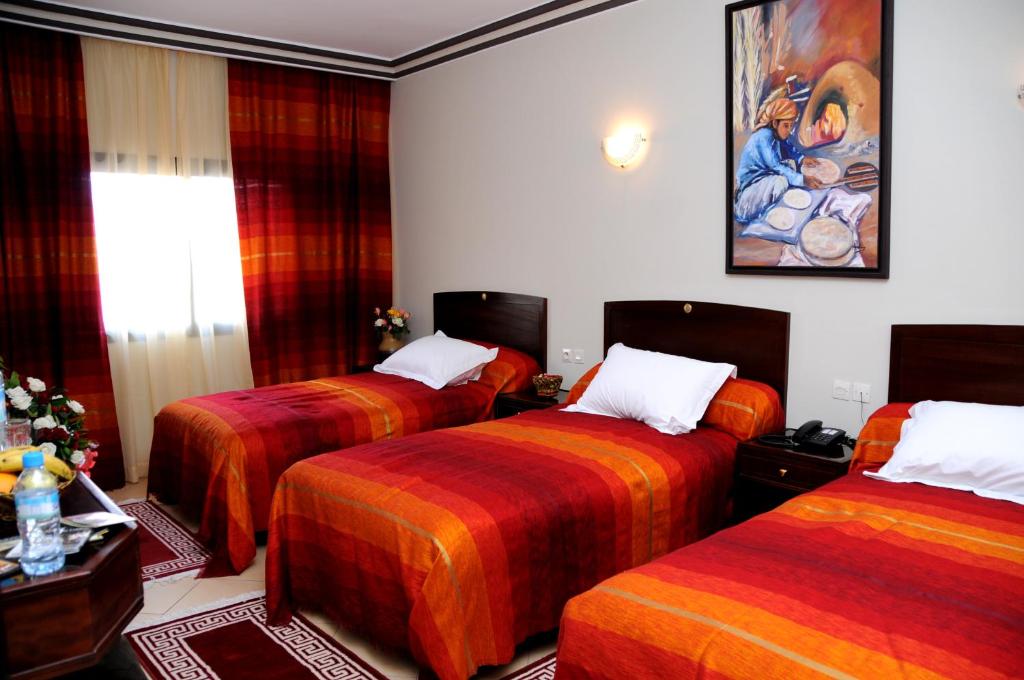 Postel nebo postele na pokoji v ubytování Residence Hotel Assounfou