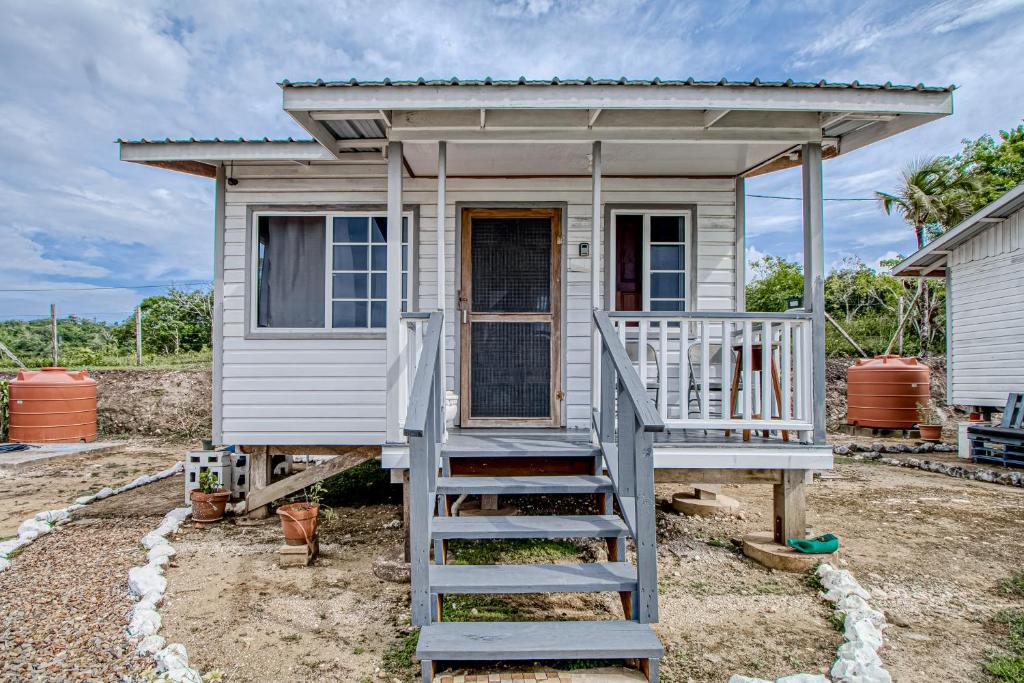 a tiny house with a staircase leading to it at Jehane Cabana at Bella Vue Estate in Georgeville