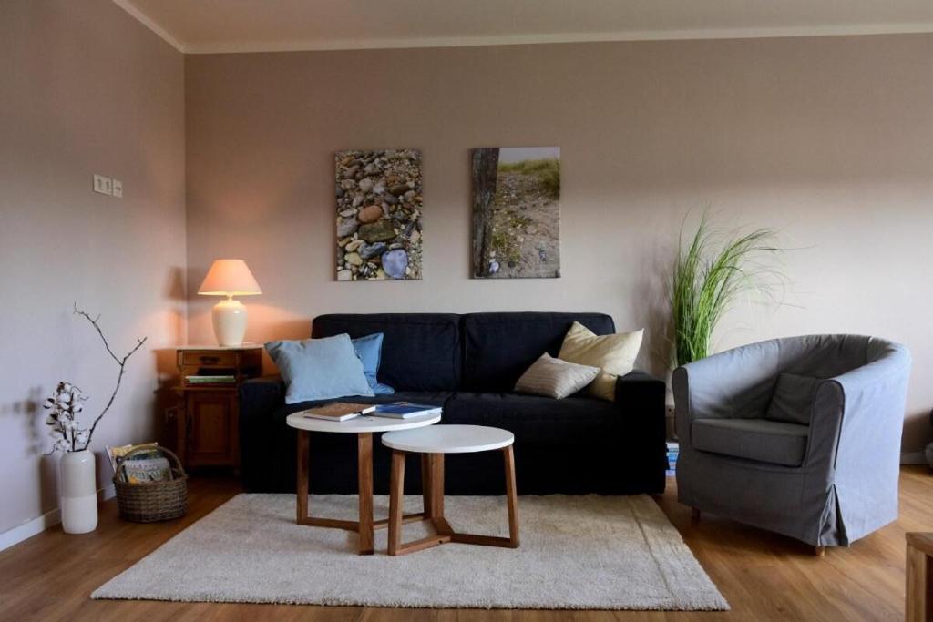 ein Wohnzimmer mit einem Sofa und einem Tisch in der Unterkunft Winsen 1 Genieße kreative FeWo zw Hamburg u. Lüneburg in Winsen