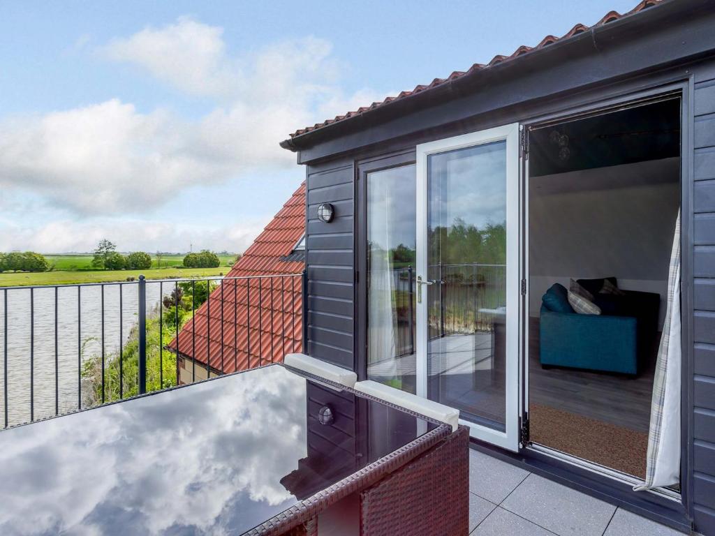 a large balcony with a view of the countryside at Home Farm Lodge in Baston