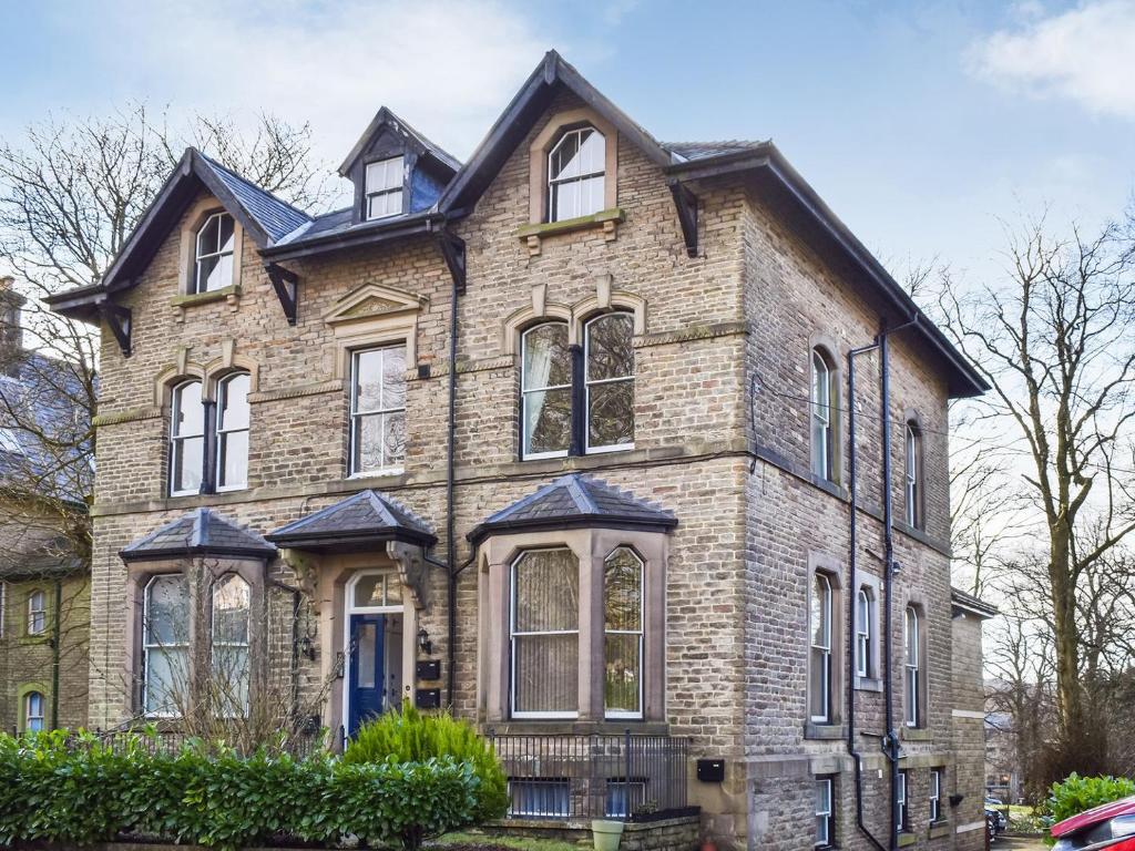 a large brick house with a black roof at No1 Park Lodge in Buxton