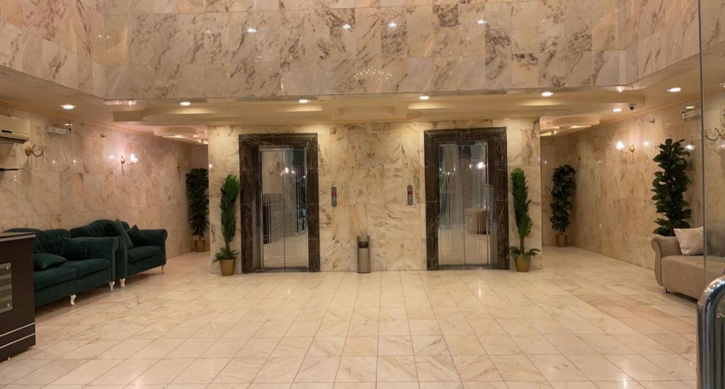 a lobby with couches and chairs in a building at غيوم in Makkah