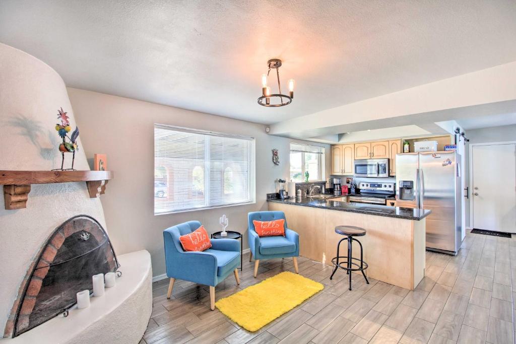 a kitchen with blue chairs and a kitchen with a tub at Vibrant, Colorful Tucson Abode w/ Pool & Hot Tub in Tucson