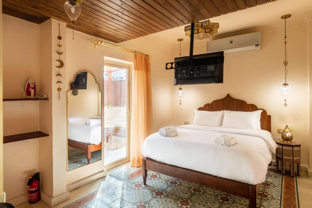 a bedroom with a large bed and a window at Marrakesh 1BDR w Jacuzzi Terrace Downtown Cairo in Cairo