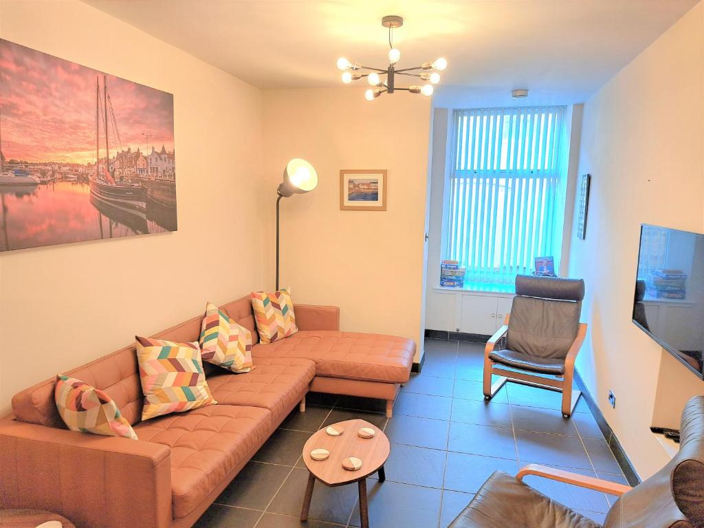 a living room with a couch and a chair at The Neuk Anstruther Sleeps 6 Fantastic Location in Anstruther