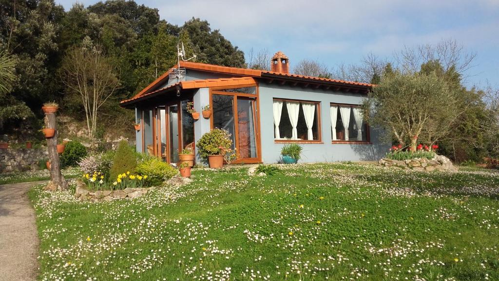 a small house in a field of flowers at La Huerta, megustarural in Llanes