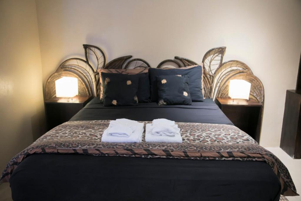a bedroom with a bed with two towels on it at Moxons Beach Club in Boscobel