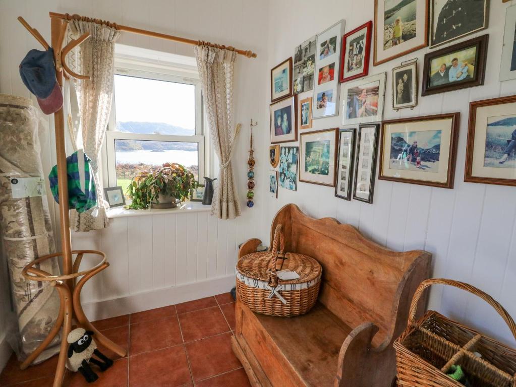 a room with a bench and pictures on the wall at Bourblach in Mallaig