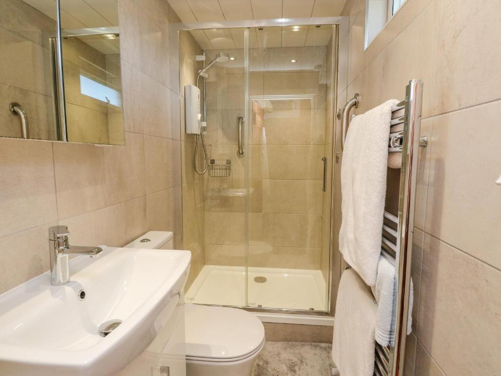 a bathroom with a shower and a sink and a toilet at Bourblach in Mallaig
