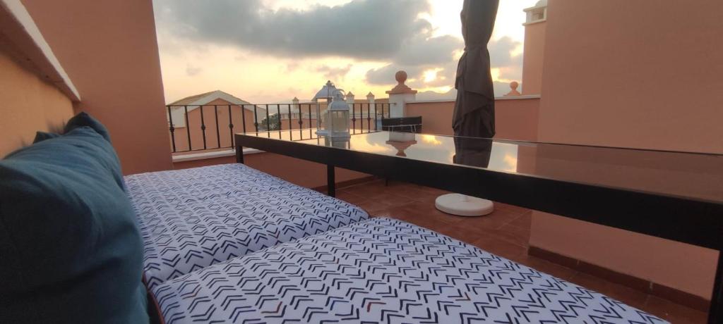 a room with a bed and a balcony with a view at Villa Terreros in San Juan de los Terreros