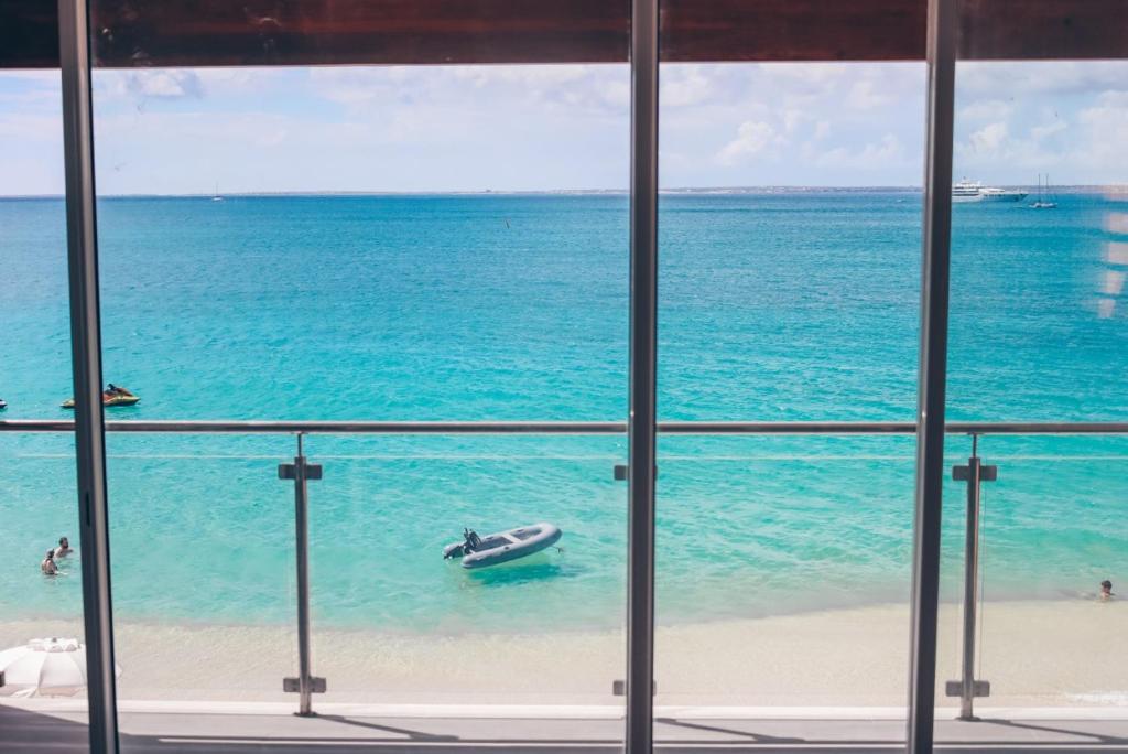 a view from a window of a boat in the ocean at PARADISE VIEW 1 bed-room water front studio at Grand Case in Grand Case