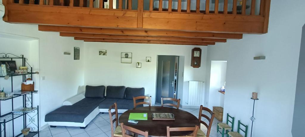 a living room with a couch and a table at Gite de POUNARD bord de rivière plage privée 