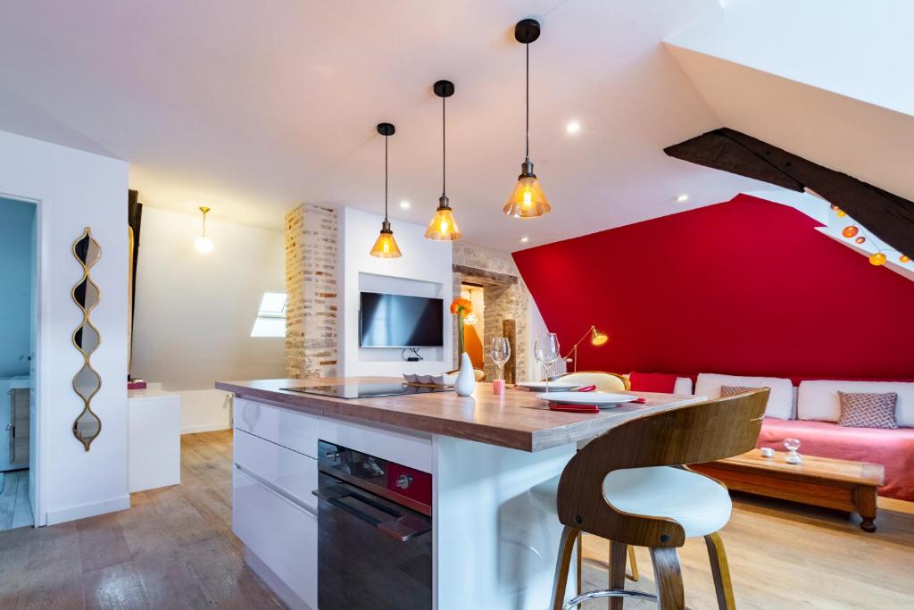 cocina y sala de estar con una pared de acento rojo en Pasteur Numéro 5, en Dijon