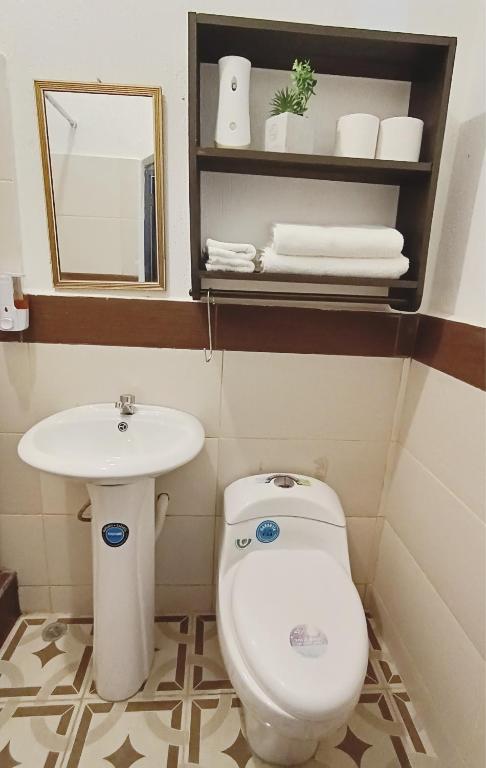 a bathroom with a toilet and a sink at Casas DiversA in Esquipulas