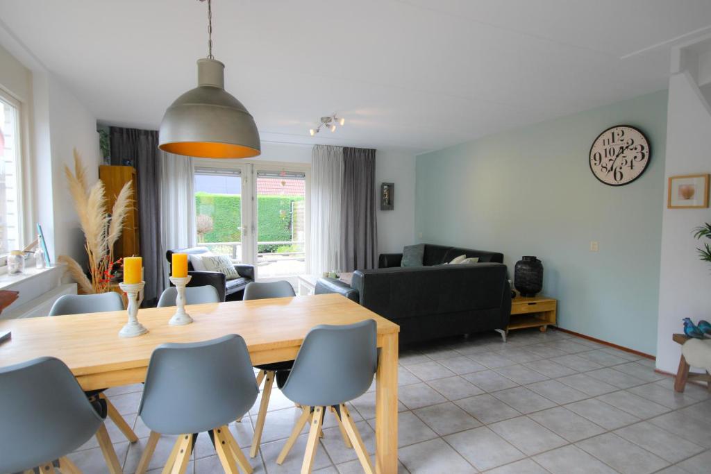 a dining room and living room with a table and chairs at Huisje 11 Wemeldinge in Wemeldinge