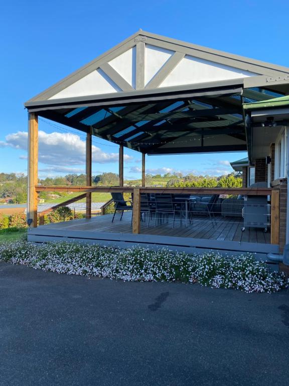 a pavilion with a picnic table and chairs under it at The Residence - Yarra Valley in Wandin North