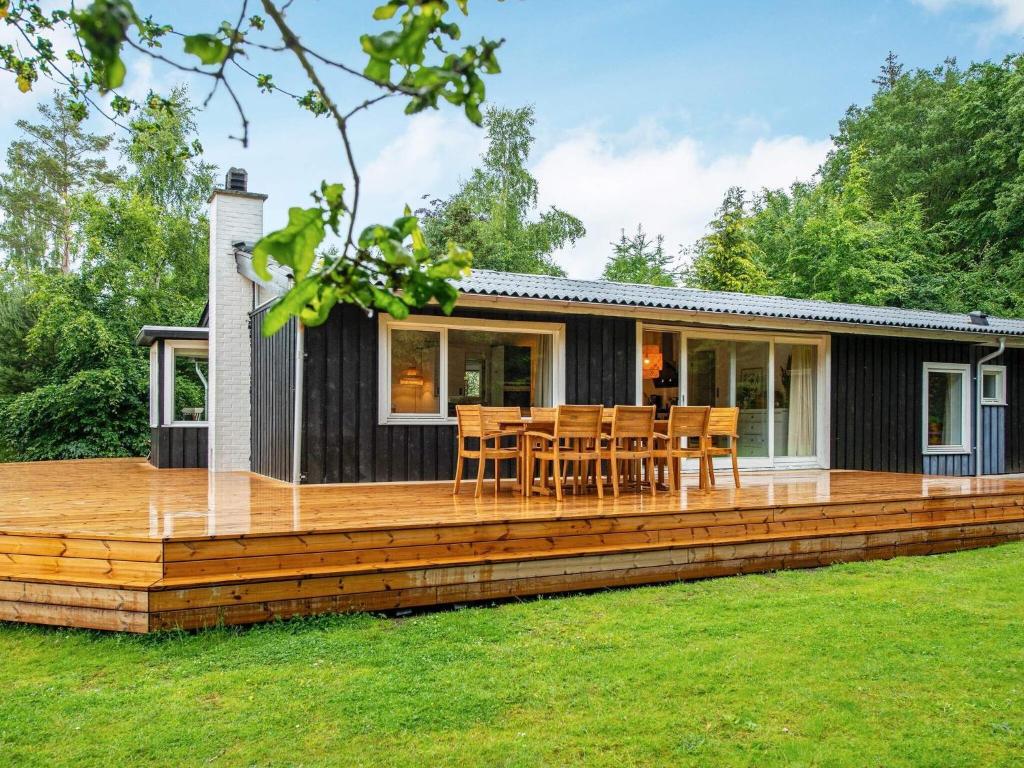 ein modulares Haus mit einer Holzterrasse in der Unterkunft Holiday home Ry IV in Ry