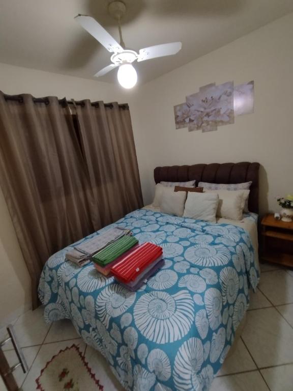 a bedroom with a bed with two suitcases on it at Casa do adalto in Ilhabela