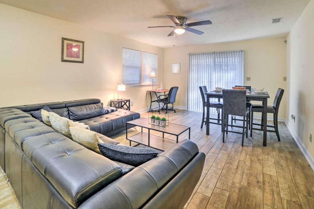 a living room with a couch and a dining room at Bright Tallahassee Home with Deck, 3 Mi to FSU! in Tallahassee