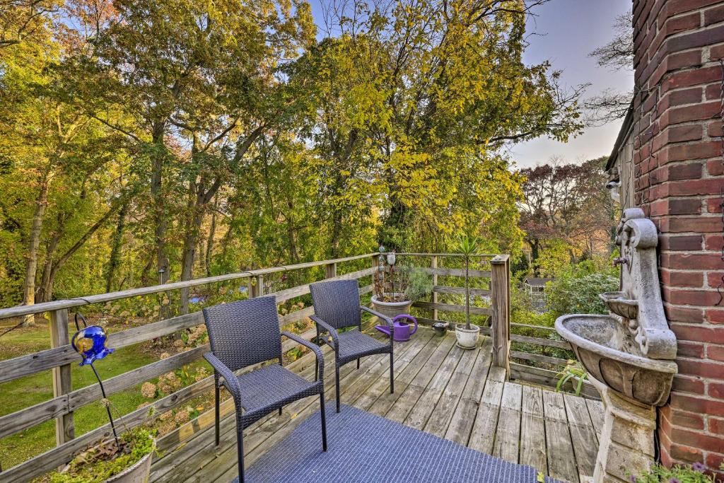 a deck with two chairs and a water fountain at Cozy Dix Hills Apt with Deck about 7 Mi to Beach! in Dix Hills