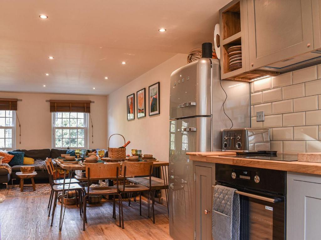 a kitchen and living room with a table and a dining room at Warrington House in Tideswell