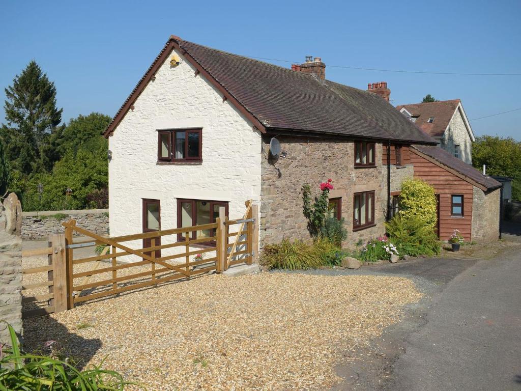 a white house with a wooden fence in front of it at Westerley Uk31573 in Clifford