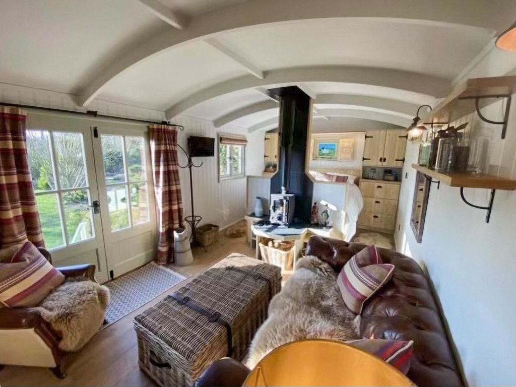 a living room with a couch and a table at Little Red House - Uk41233 in Shelve