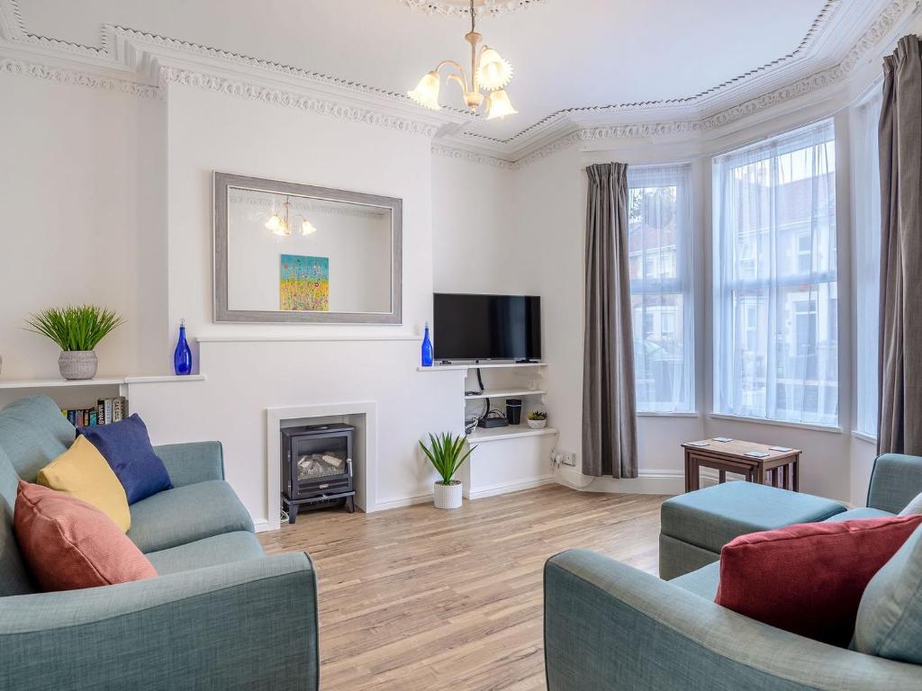 a living room with two couches and a fireplace at Newlands Nook in Weston-super-Mare