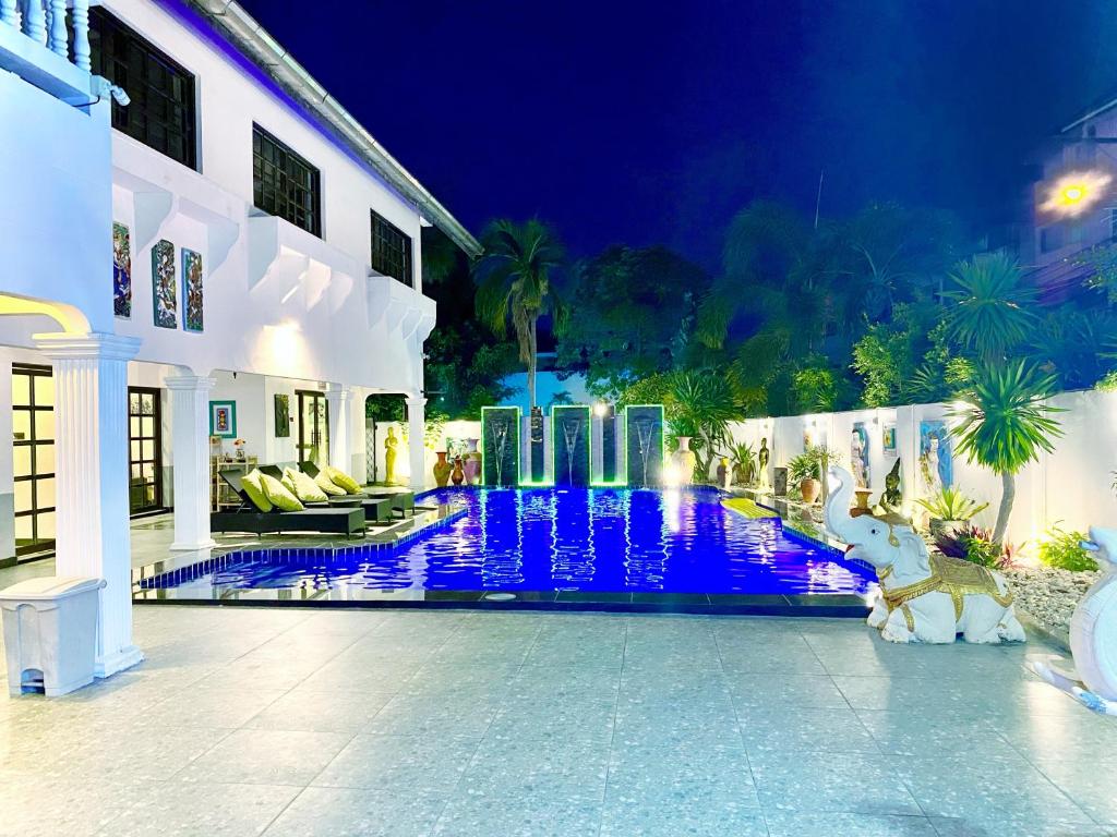a villa with a swimming pool at night at Wan Wan พูลวิลล่า พัทยา in Nong Prue