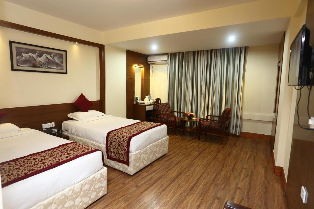 Postel nebo postele na pokoji v ubytování Hotel Woodland Kathmandu