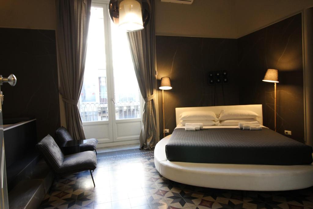 A bed or beds in a room at Duomo Housing Catania Le Suites