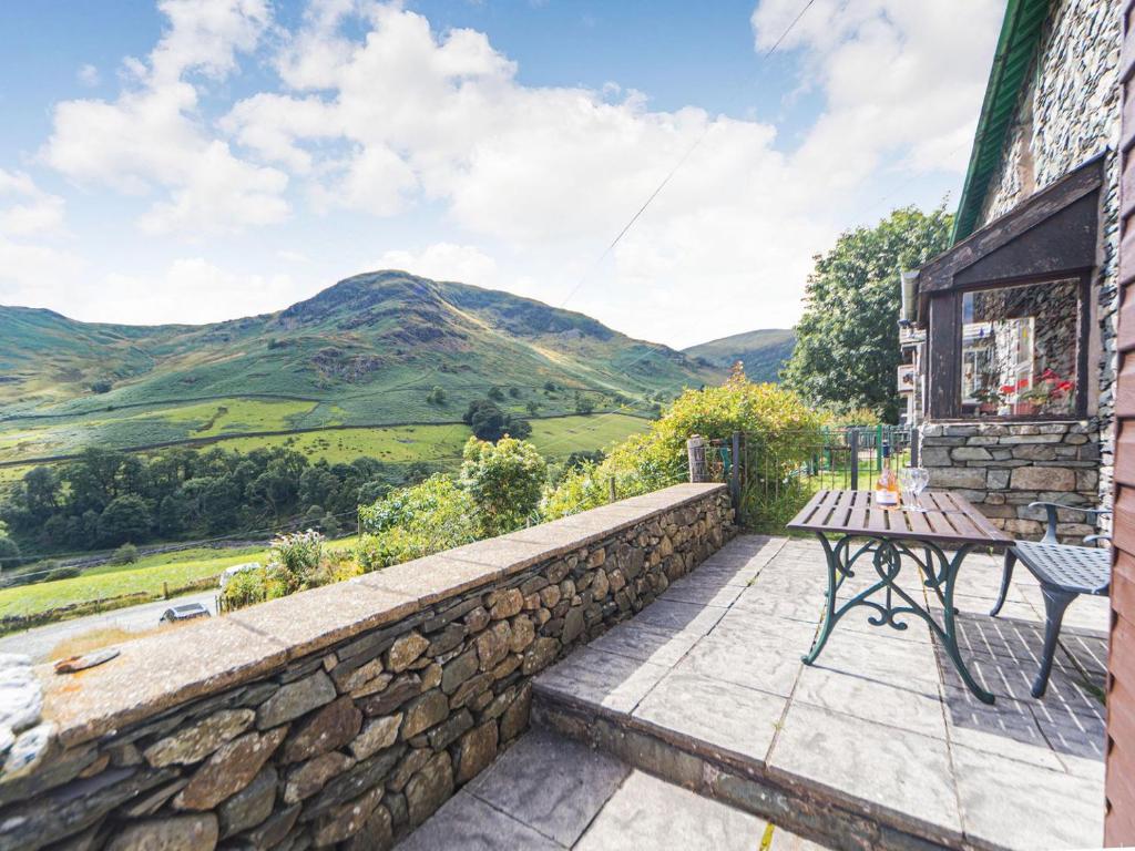 a patio with a table and a view of mountains at High Rake in Glenridding