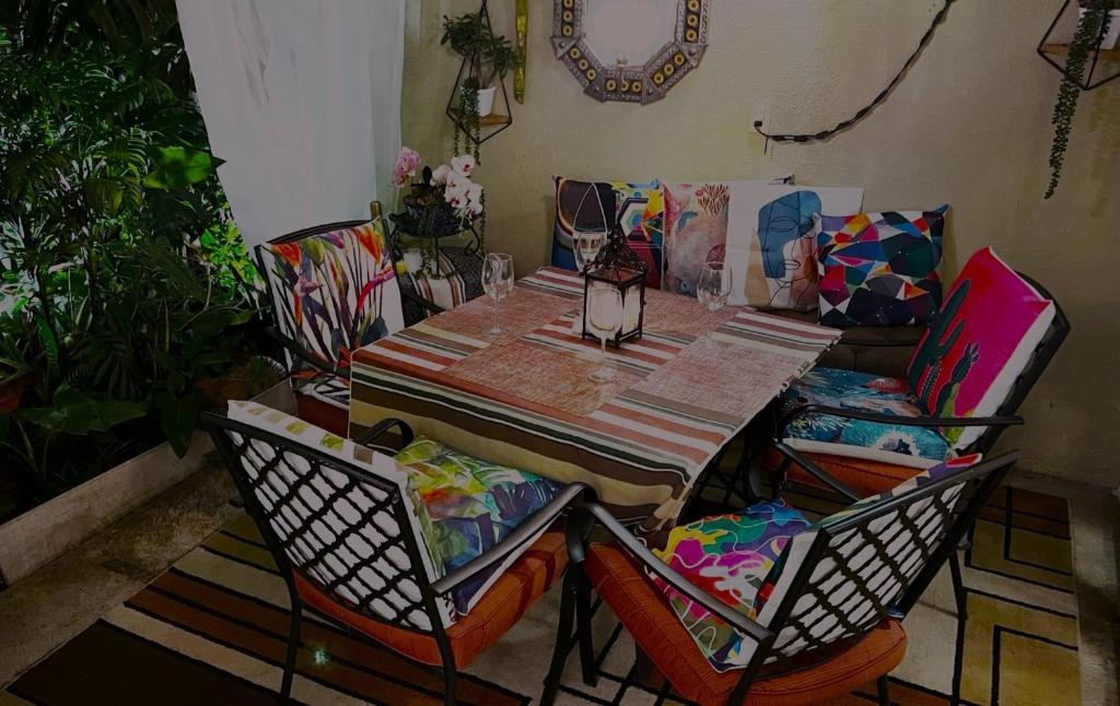 a dining room table with chairs and a couch at Dickinson Guest House, Guadalajara Expo in Guadalajara
