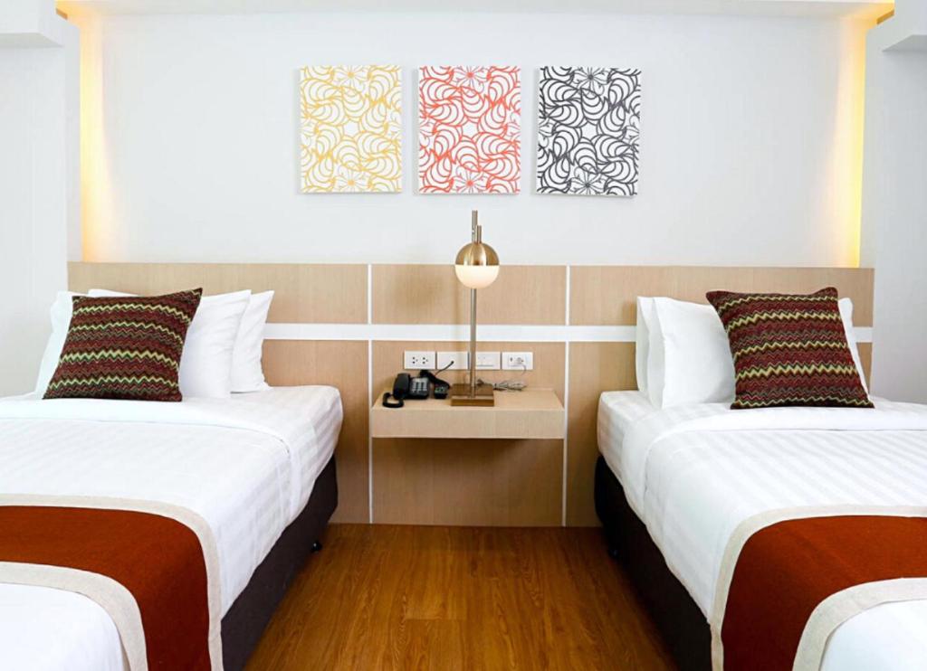 Postel nebo postele na pokoji v ubytování Sann Hotel