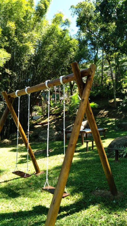 a wooden swing set in a park at Pousada Hang Conectada com a Natureza in Florianópolis