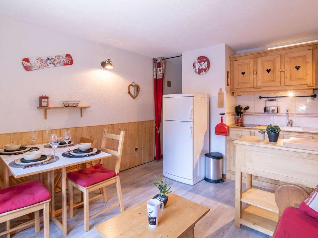 a kitchen and dining room with a table and a refrigerator at Appartement Saint-Lary-Soulan, 2 pièces, 4 personnes - FR-1-296-331 in Saint-Lary-Soulan