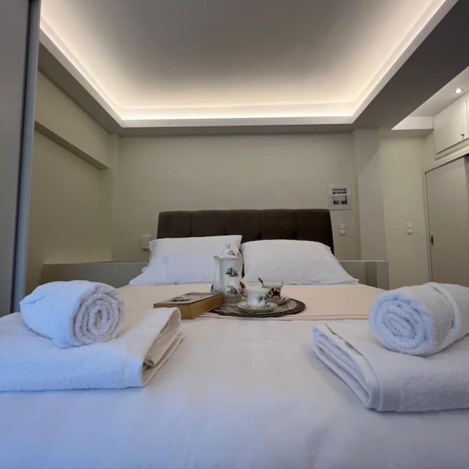 a white bed with towels on top of it at Luxury Studio “Atene” in Athens