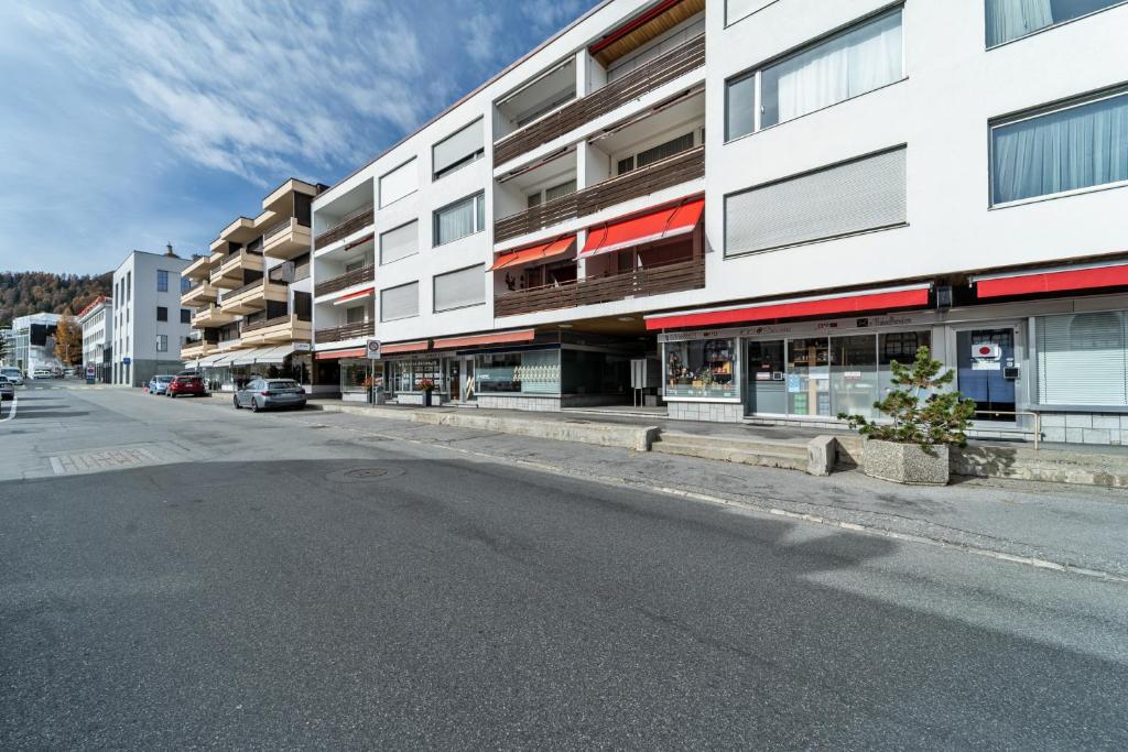 an empty street in front of a building at Allod Brattas - Sankt Moritz in St. Moritz