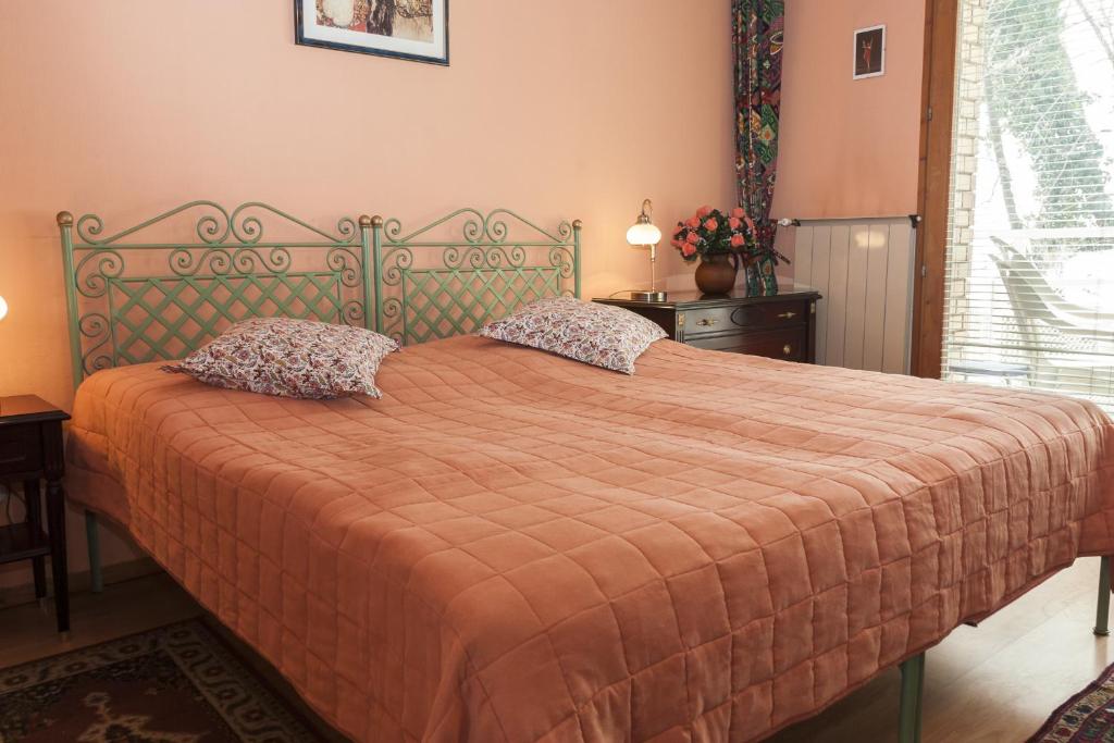 a bedroom with a large bed with a orange bedspread at Bellevue Budapest B&B in Budapest