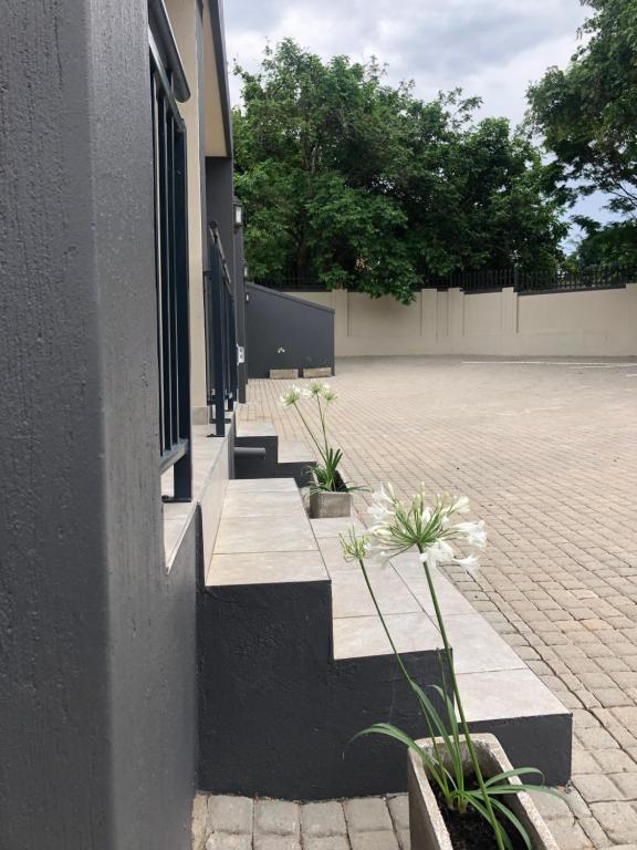 a building with some plants on the side of it at Spring Acres Guesthouse in Nelspruit
