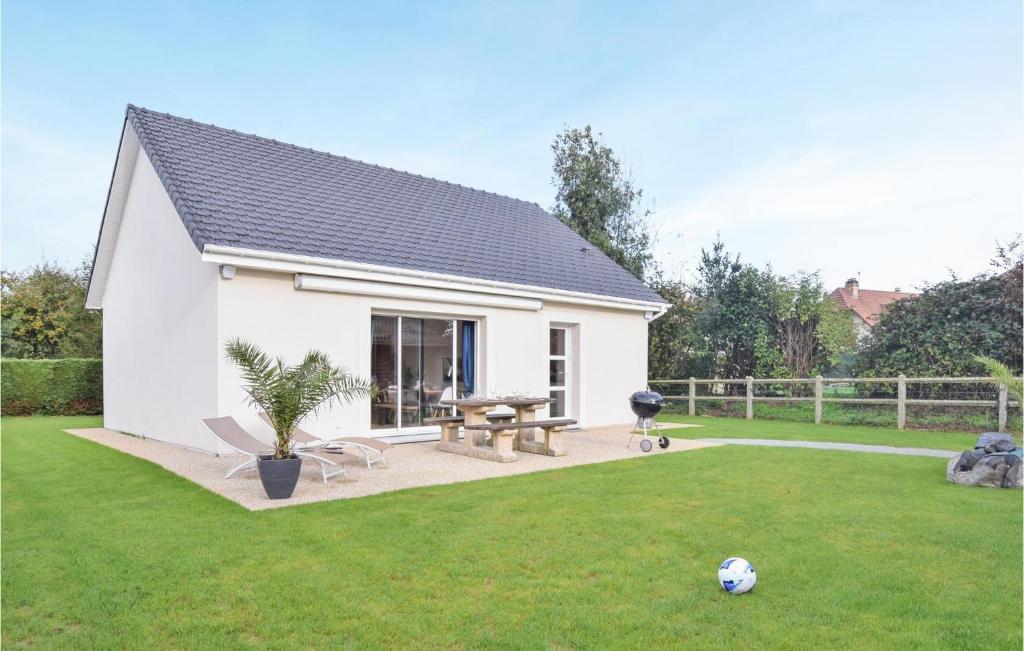 a small white house with a picnic table in a yard at Beautiful Home In Angerville-lorcher With Wifi in Angerville-lʼOrcher