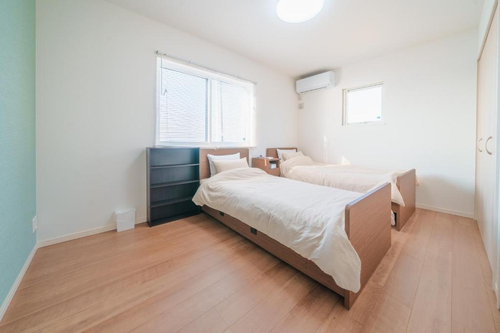Postel nebo postele na pokoji v ubytování Ryu shi ma Ocean View Villa