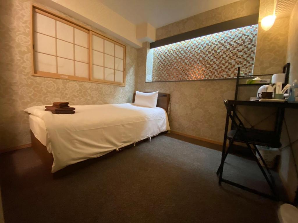 Postel nebo postele na pokoji v ubytování Allcomein Hotel Akihabara