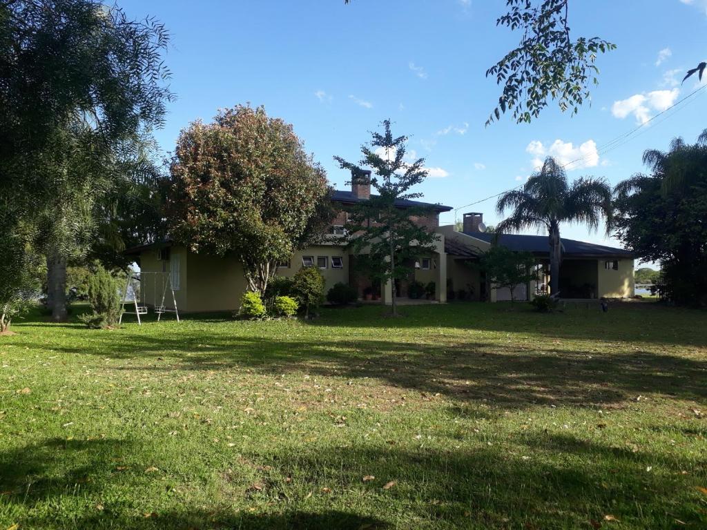 a house with a large yard in front of it at Casa de Campo LA CANTERA in Federación
