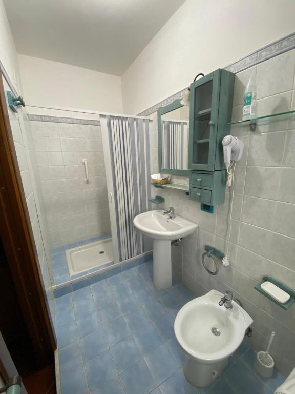 a bathroom with a sink and a toilet and a shower at Villa Franca in Reggio Calabria