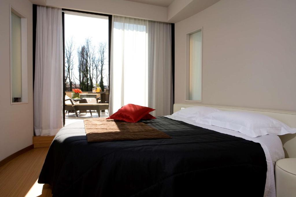 Postel nebo postele na pokoji v ubytování Best Western Plus Hotel Galileo Padova