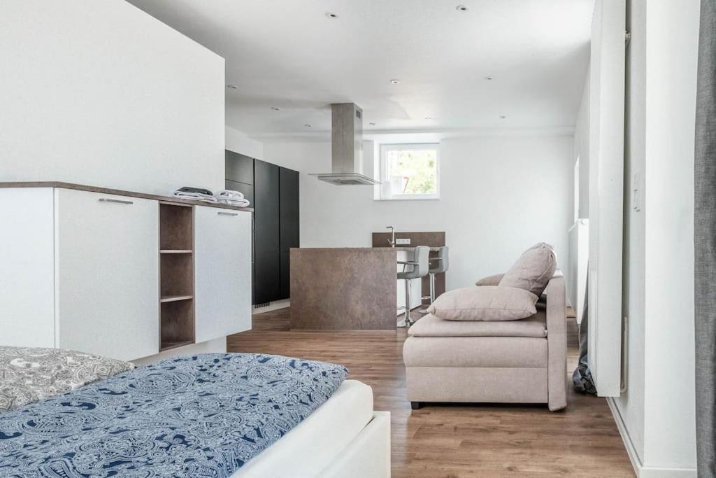 a room with a bed and a couch and a chair at Loft mit großer Terrasse bei der Kinderklinik 2C in Siegen
