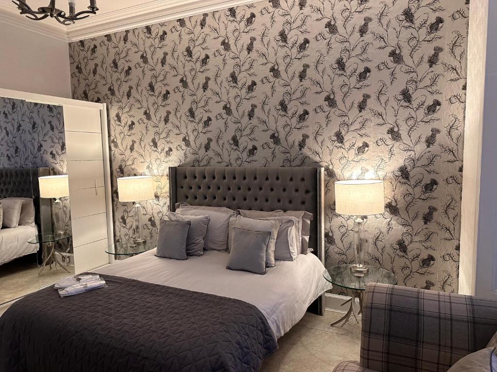 a bedroom with a bed with a floral wallpaper at No 9 retreat in Prestwick