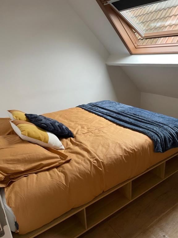 a bed in a room with a window at Antwerpcityhome in Antwerp