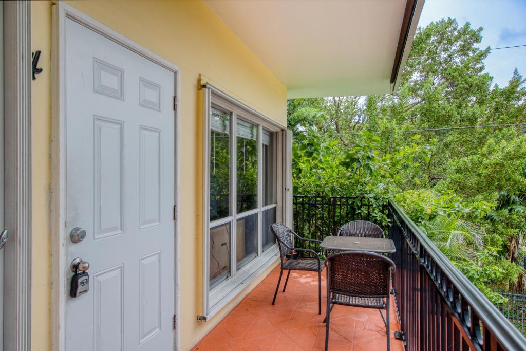 a porch with two chairs and a table on a balcony at Ocean Reef At Deerfield #4 in Deerfield Beach